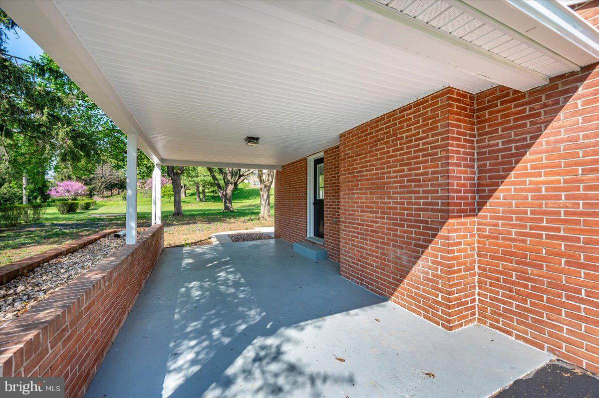13616 Royal Road Hagerstown, MD 21742 - Photo 49 of 57 Charming brick entryway in nature's embrace.