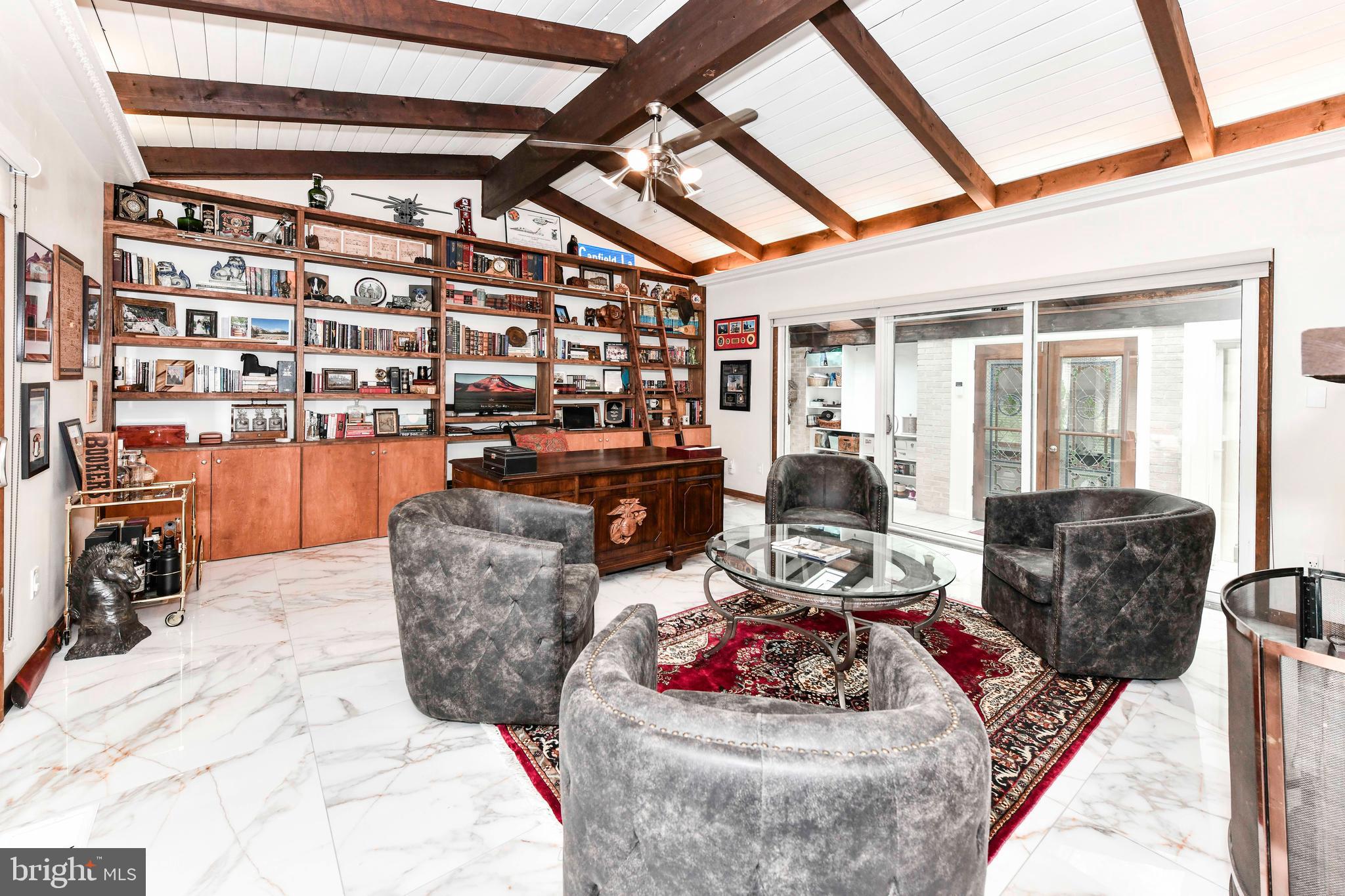 7833 Willowbrook Road Fairfax Station, VA 22039 - Photo 3 of 51 a living room with furniture and a floor to ceiling window