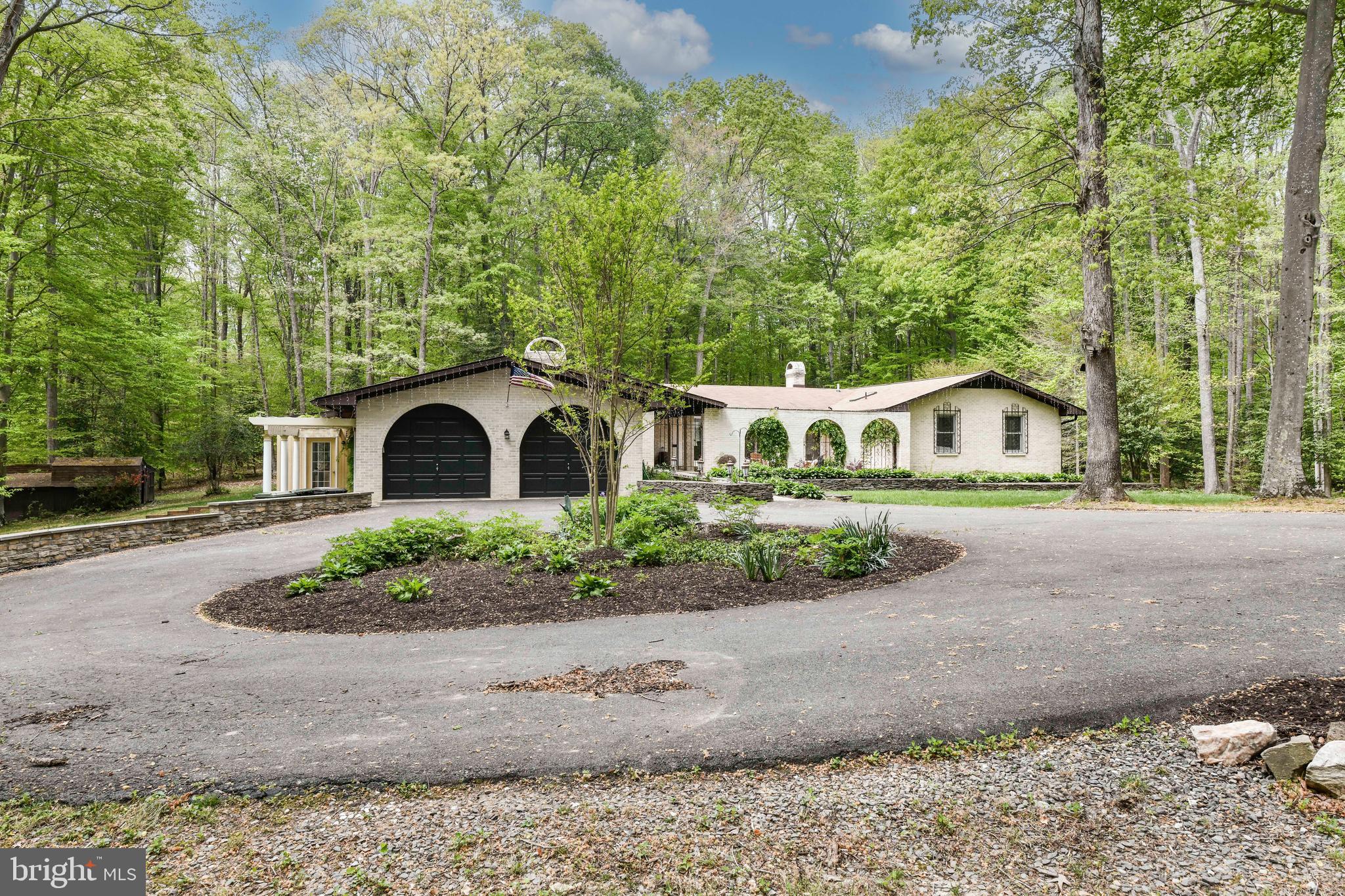 7833 Willowbrook Road Fairfax Station, VA 22039 - Photo 47 of 51 a front view of a house with garden