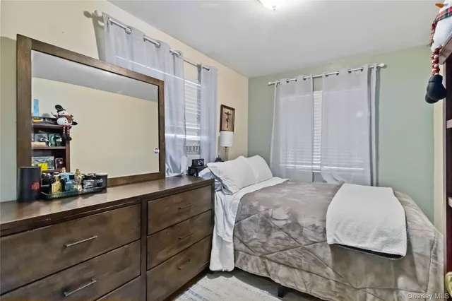 a bedroom with a bed and a mirror