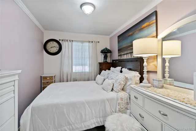 a bedroom with a bed and a lamp