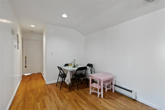 a workspace room with wooden floor and furniture