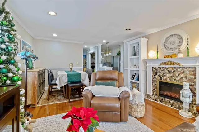a living room with furniture a fireplace and a potted plant