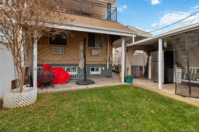 a view of a house with backyard porch and furniture