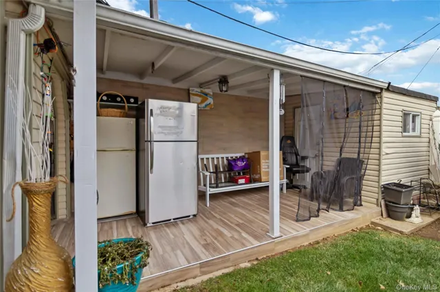 a view of a porch with wooden door and a car door