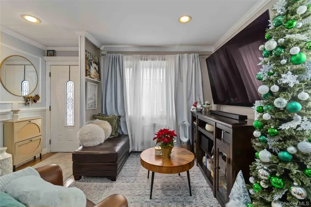a living room with furniture a potted plant and a fireplace