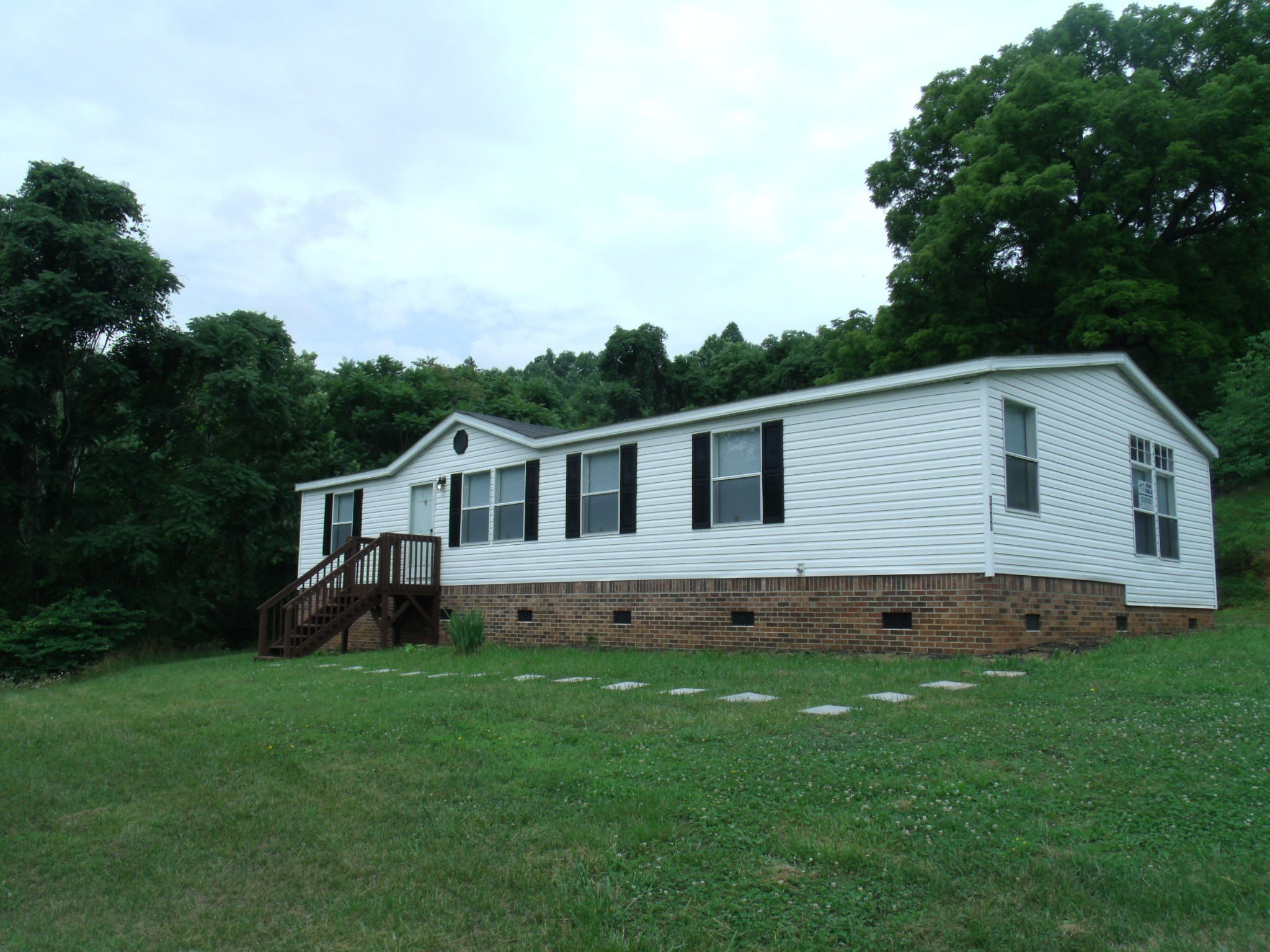 1008 Black Jack Road Stuart, VA 24171 - Photo 2 of 14 a house that is sitting in the grass