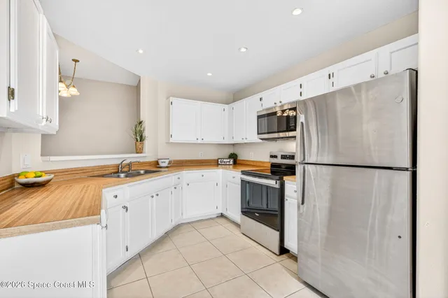 a kitchen with granite countertop cabinets appliances and a counter space