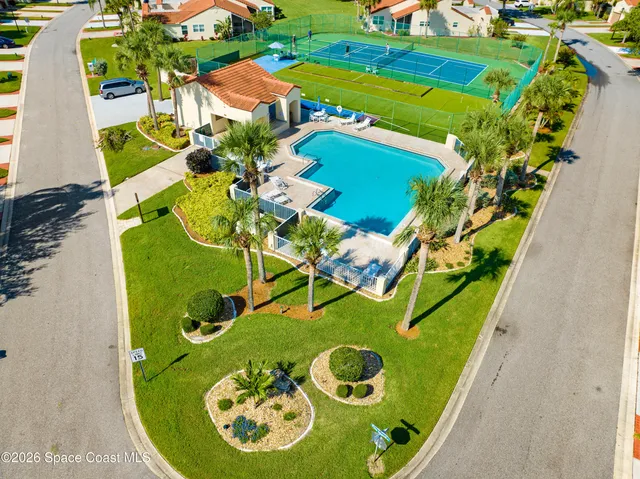 an aerial view of a house with swimming pool garden and patio