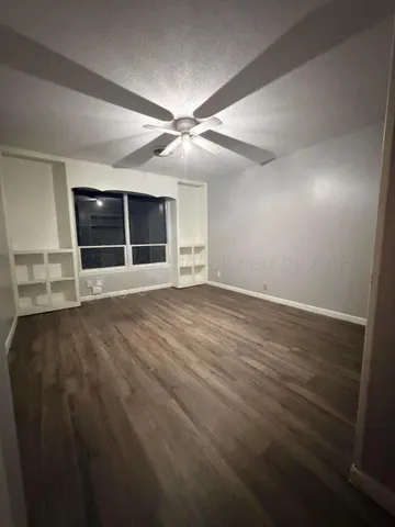 an empty room with a empty space and windows