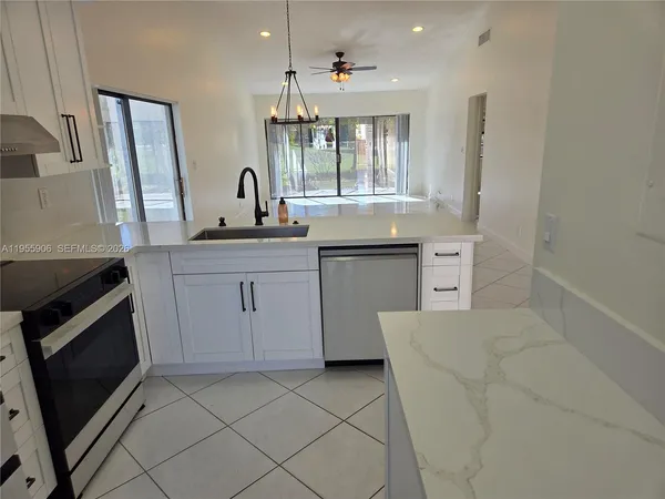 a kitchen with a sink stove and cabinets