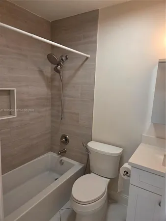 a white toilet and a shower curtain