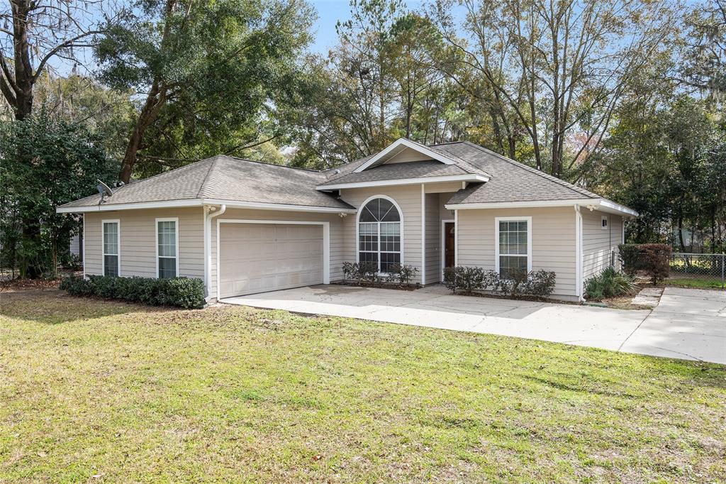 3637 Northwest 8th Avenue Gainesville, FL 32607 - Photo 1 of 1 a front view of a house with a yard and garage