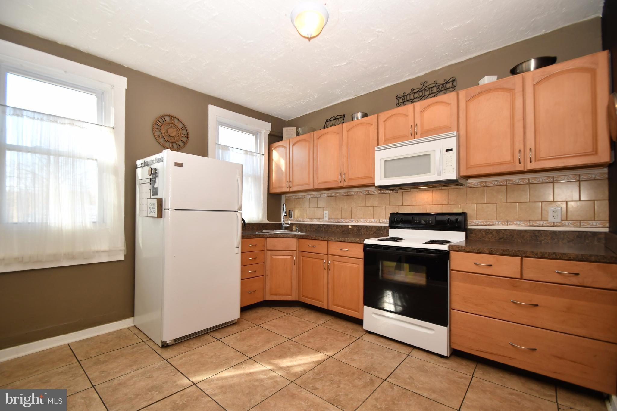1095 Colora Road Colora, MD 21917 - Photo 11 of 29 a kitchen with a refrigerator sink and cabinets