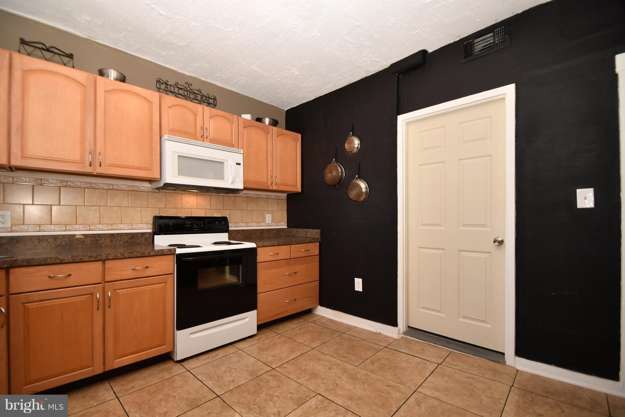 1095 Colora Road Colora, MD 21917 - Photo 13 of 29 a kitchen with stainless steel appliances granite countertop a refrigerator and a sink