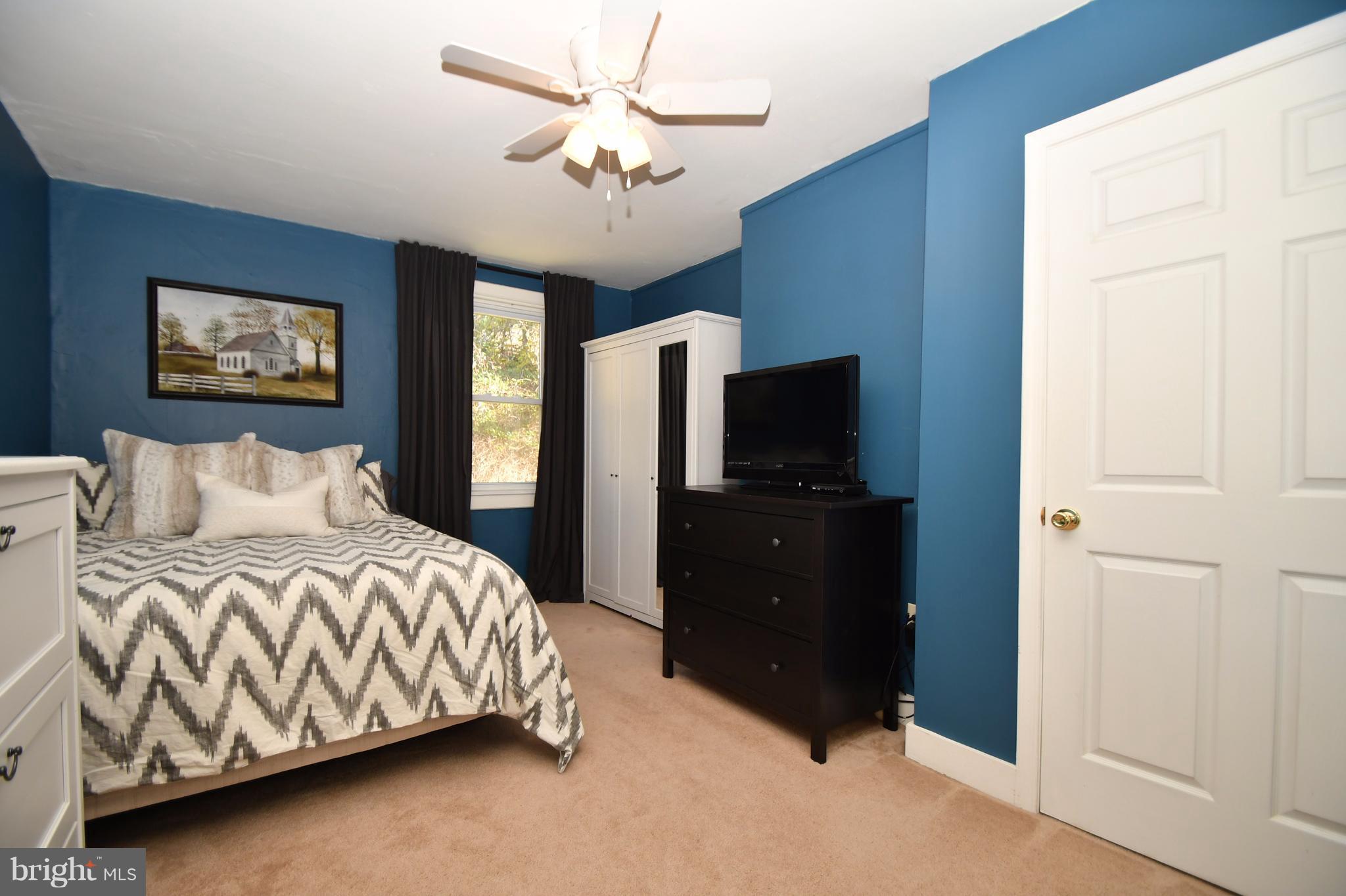 1095 Colora Road Colora, MD 21917 - Photo 20 of 29 a bedroom with a bed and a tv on a dresser