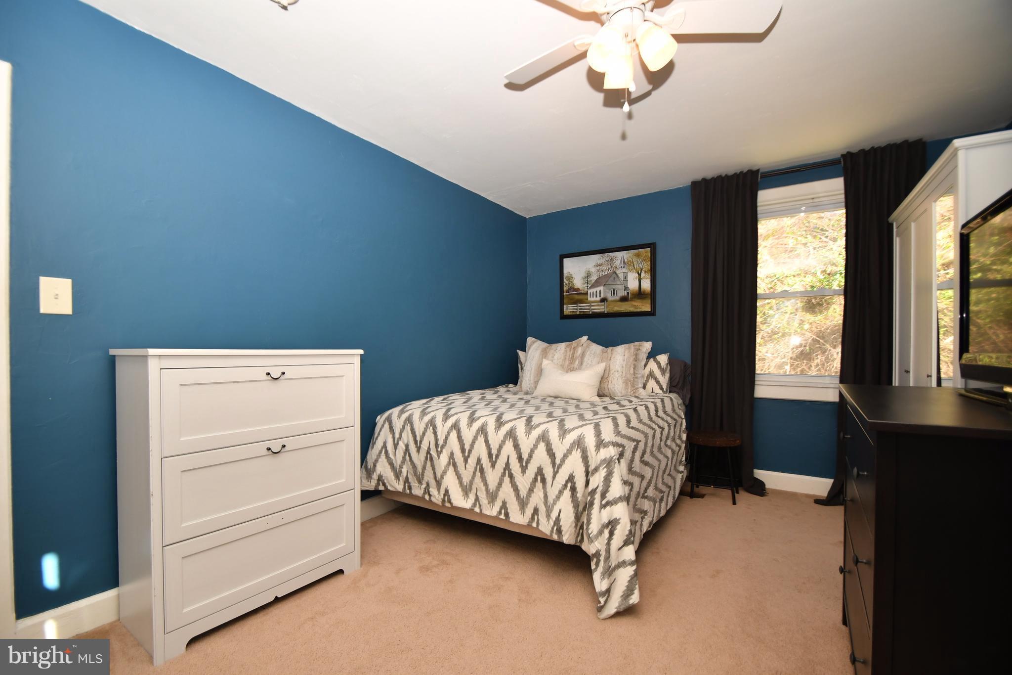 1095 Colora Road Colora, MD 21917 - Photo 21 of 29 a bedroom with a bed and a chandelier