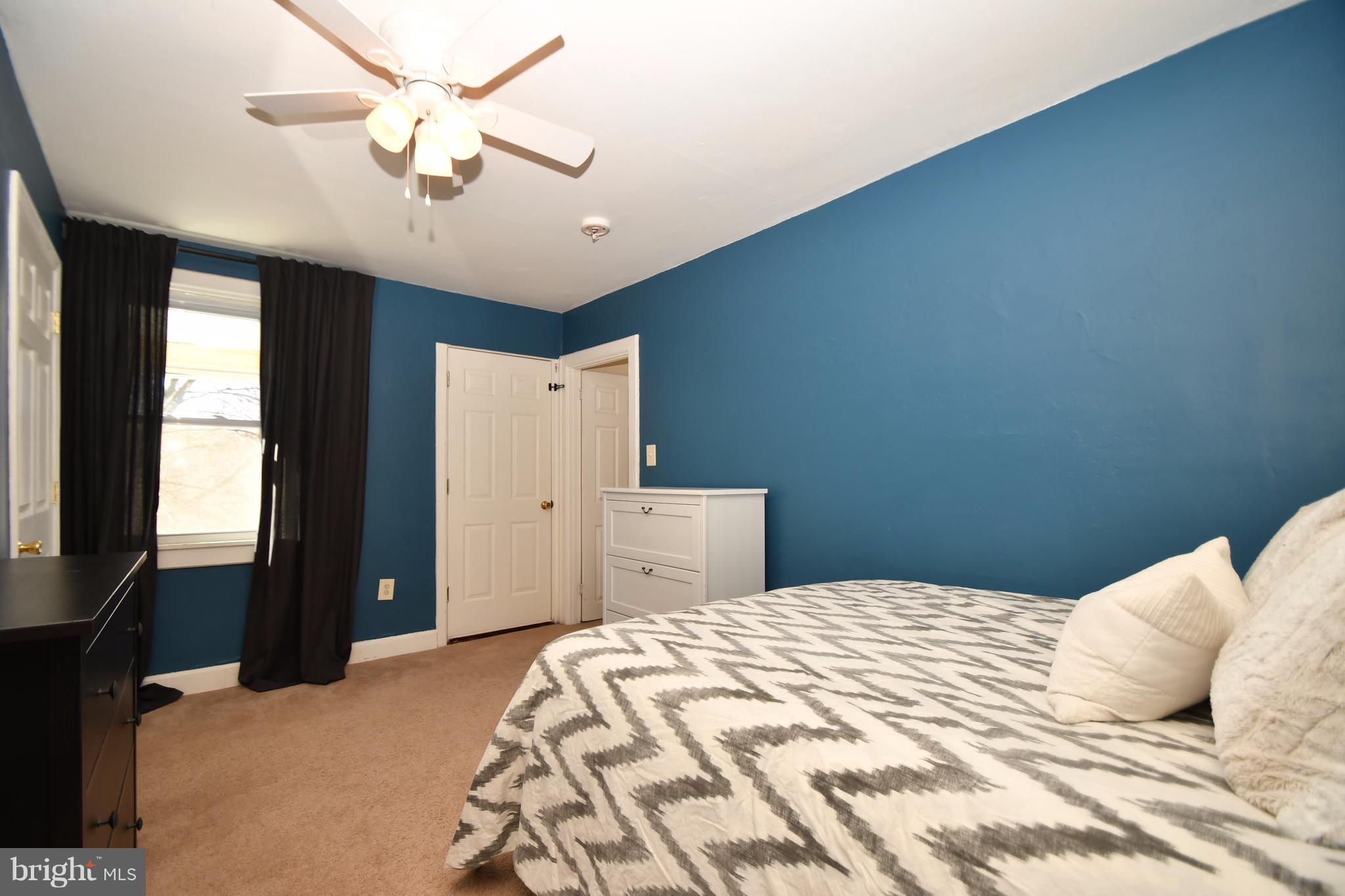 1095 Colora Road Colora, MD 21917 - Photo 22 of 29 a bedroom with a large bed and a chandelier