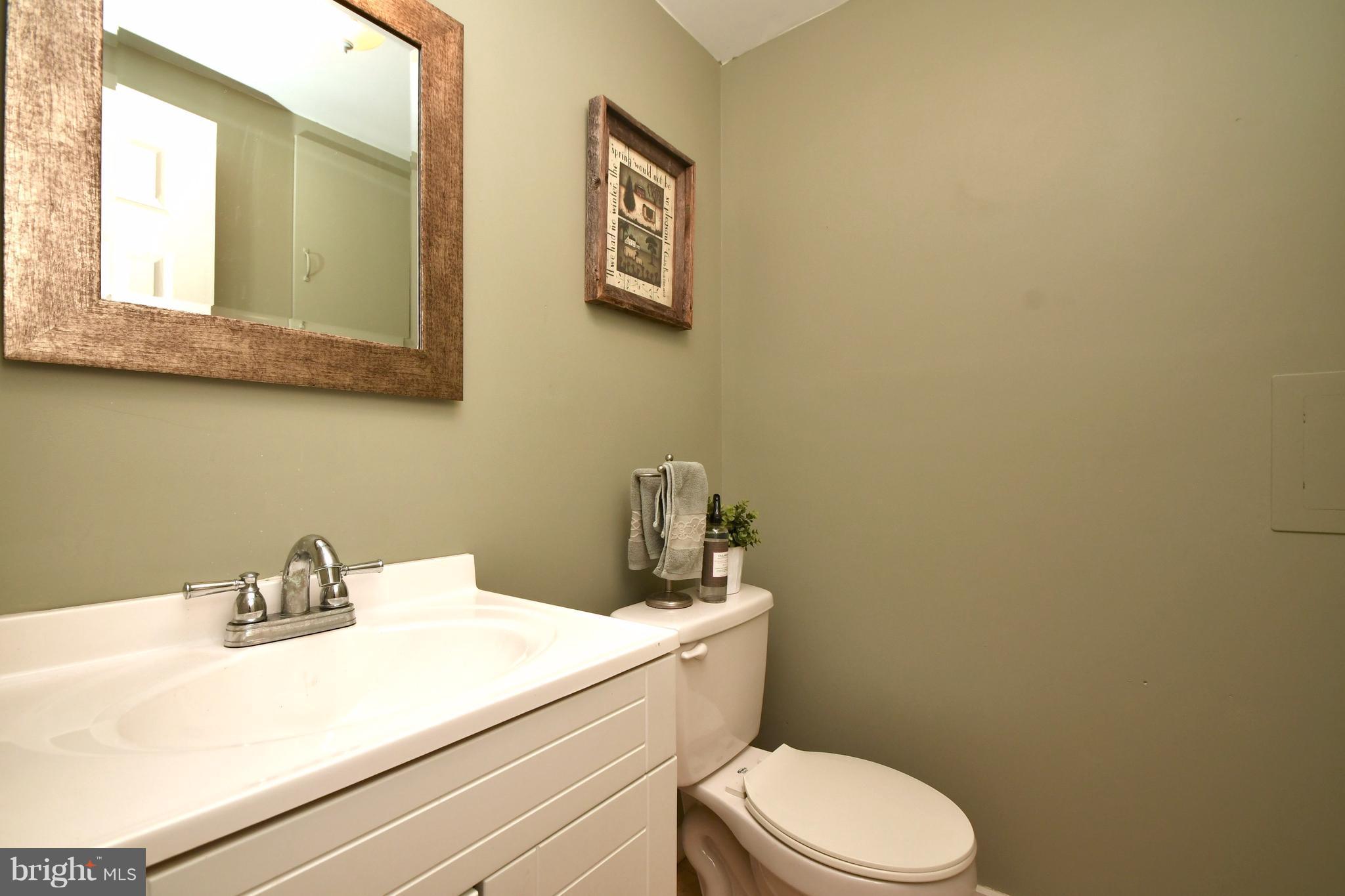 1095 Colora Road Colora, MD 21917 - Photo 10 of 29 a bathroom with a sink mirror and toilet