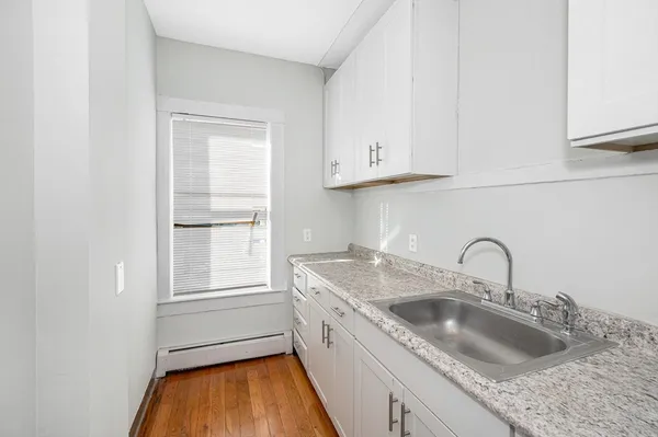 a kitchen with granite countertop a sink and a window