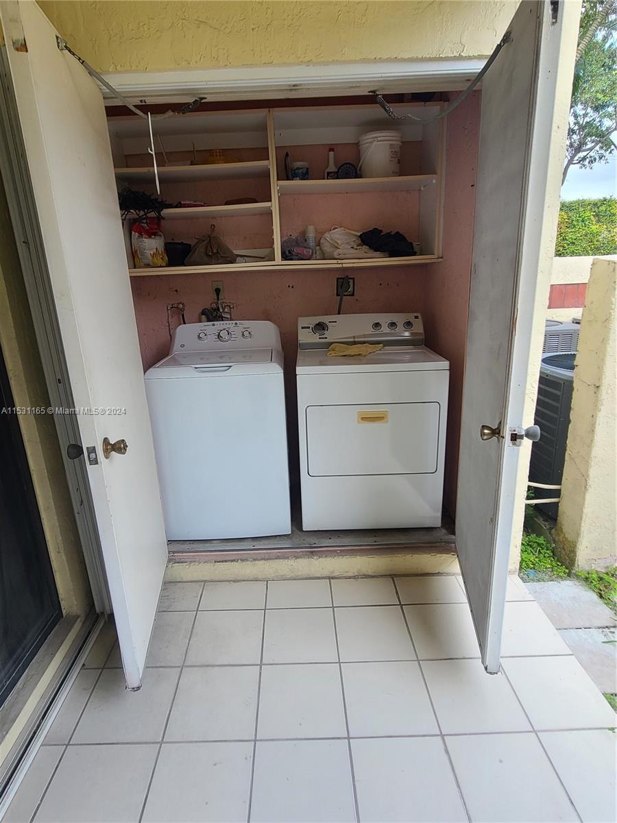 8807 Southwest 130th Place, Unit 102 Miami, FL 33186 - Photo 15 of 18 a utility room with washer and dryer