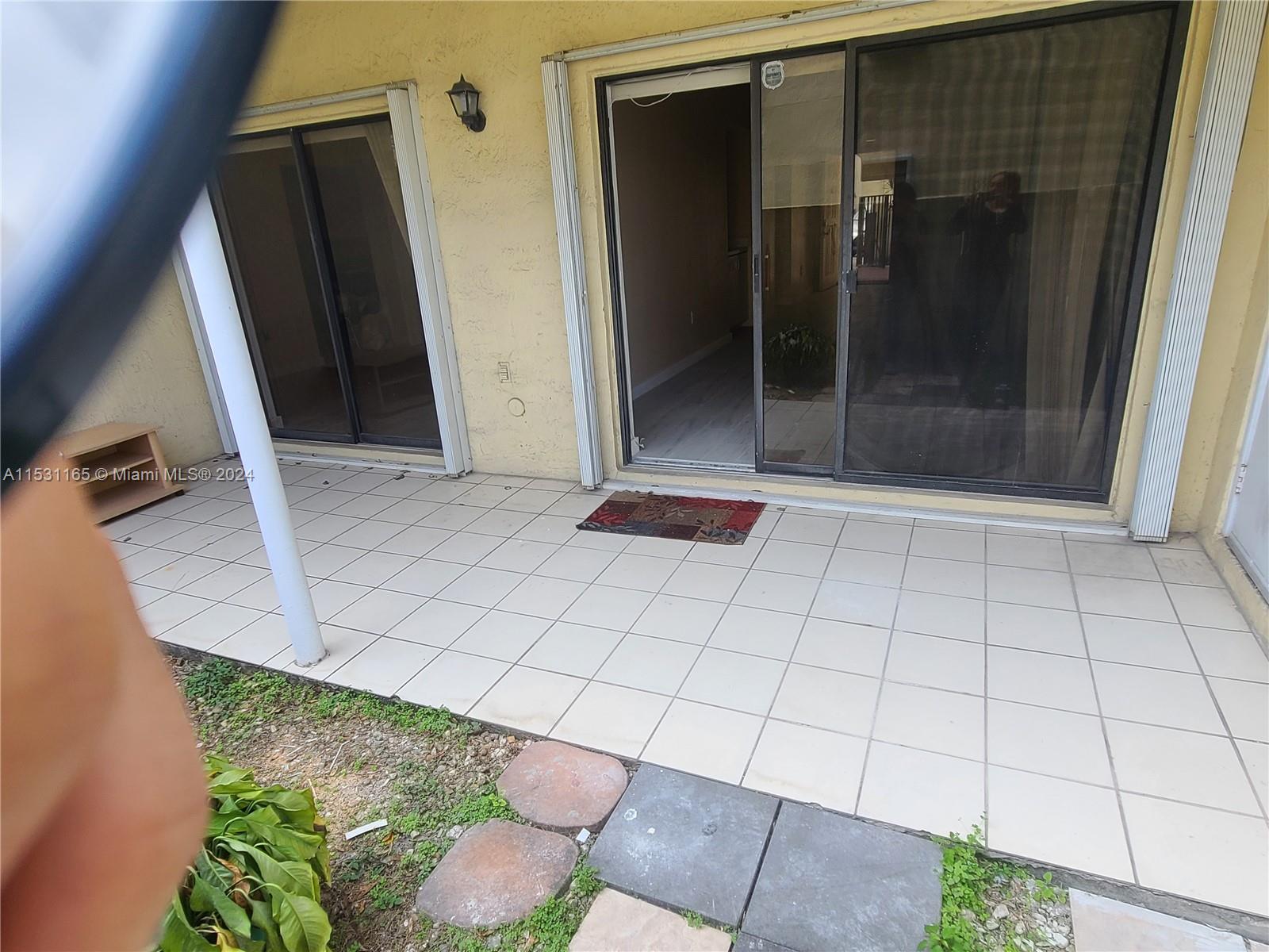 8807 Southwest 130th Place, Unit 102 Miami, FL 33186 - Photo 17 of 18 a view of an empty room with wooden floor and a bathroom sink