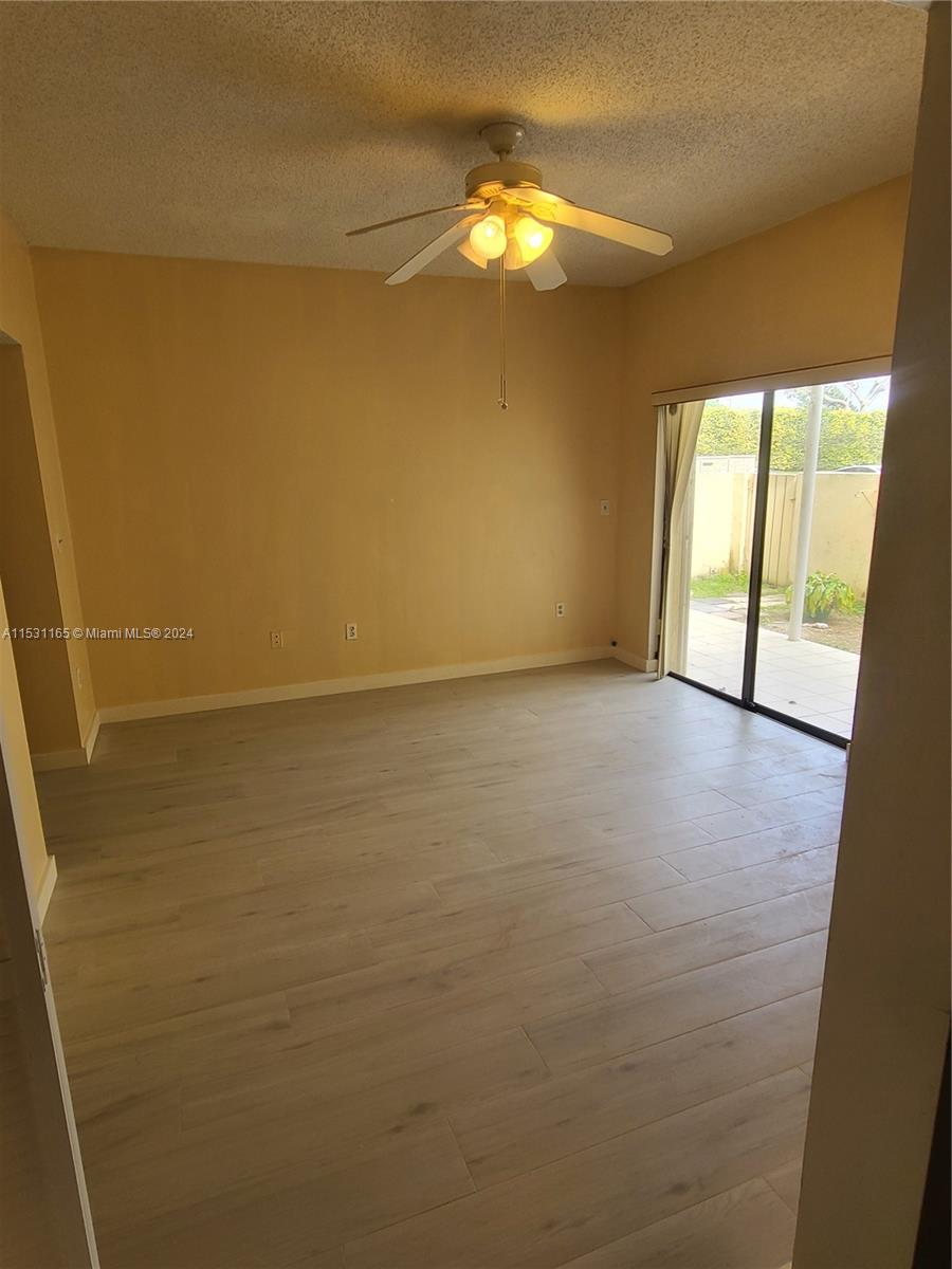8807 Southwest 130th Place, Unit 102 Miami, FL 33186 - Photo 6 of 18 a view of an empty room and window