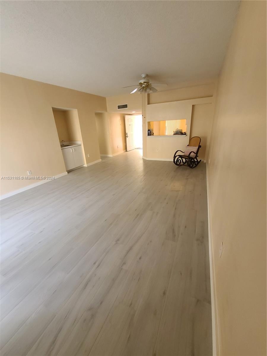 8807 Southwest 130th Place, Unit 102 Miami, FL 33186 - Photo 8 of 18 a view of a livingroom with storage and utility