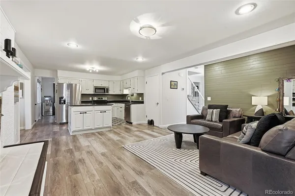 a living room with furniture and kitchen view