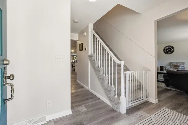 a view of a hallway with wooden floor and entryway