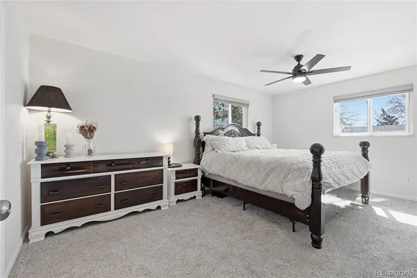 a bed room with a bed and a ceiling fan