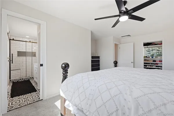 a bedroom with a bed and a painting on the wall