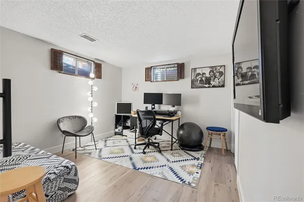 a view of a livingroom with workspace and a couch