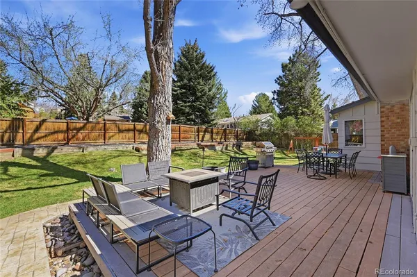 a view of a backyard with sitting area