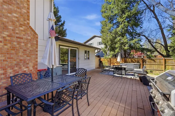 a view of a dinning table and chairs in patio of the house