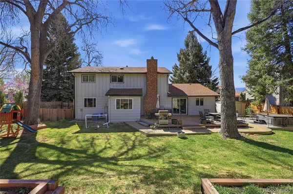 a view of a patio with table and chairs under an umbrella