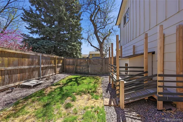 a view of a backyard with wooden fence