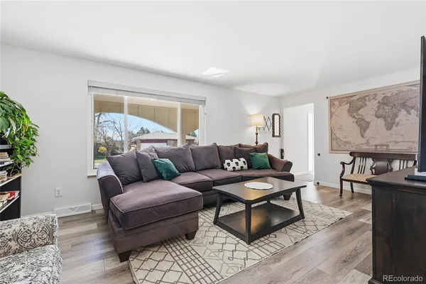 a living room with furniture and wooden floor