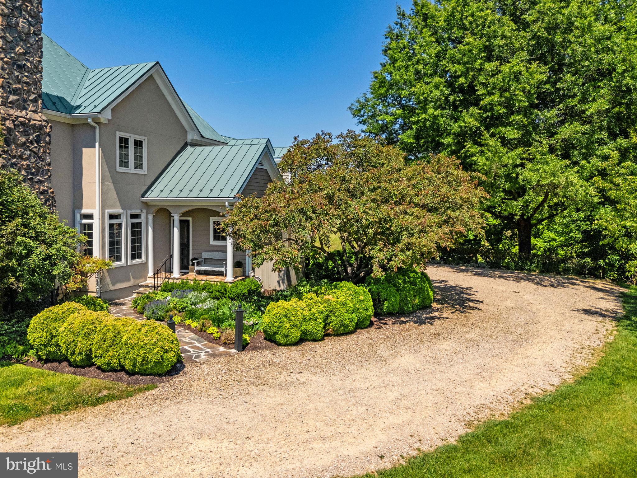 36190 Turkey Roost Road Middleburg, VA 20117 - Photo 80 of 88 a front view of a house with a garden and plants