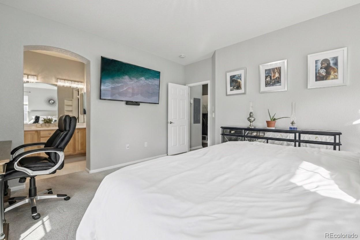 224 Whitehaven Circle Highlands Ranch, CO 80129 - Photo 15 of 34 a bedroom with a bed and a flat screen tv