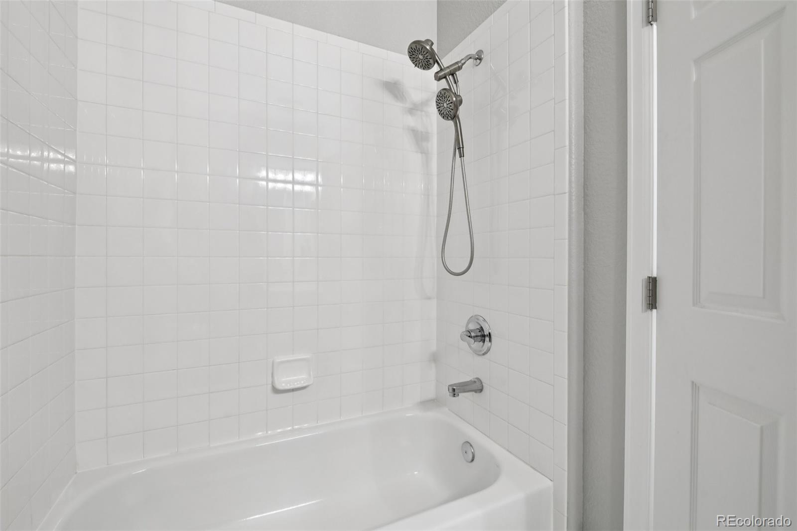 224 Whitehaven Circle Highlands Ranch, CO 80129 - Photo 24 of 34 a bathroom with a bath tub with a shower