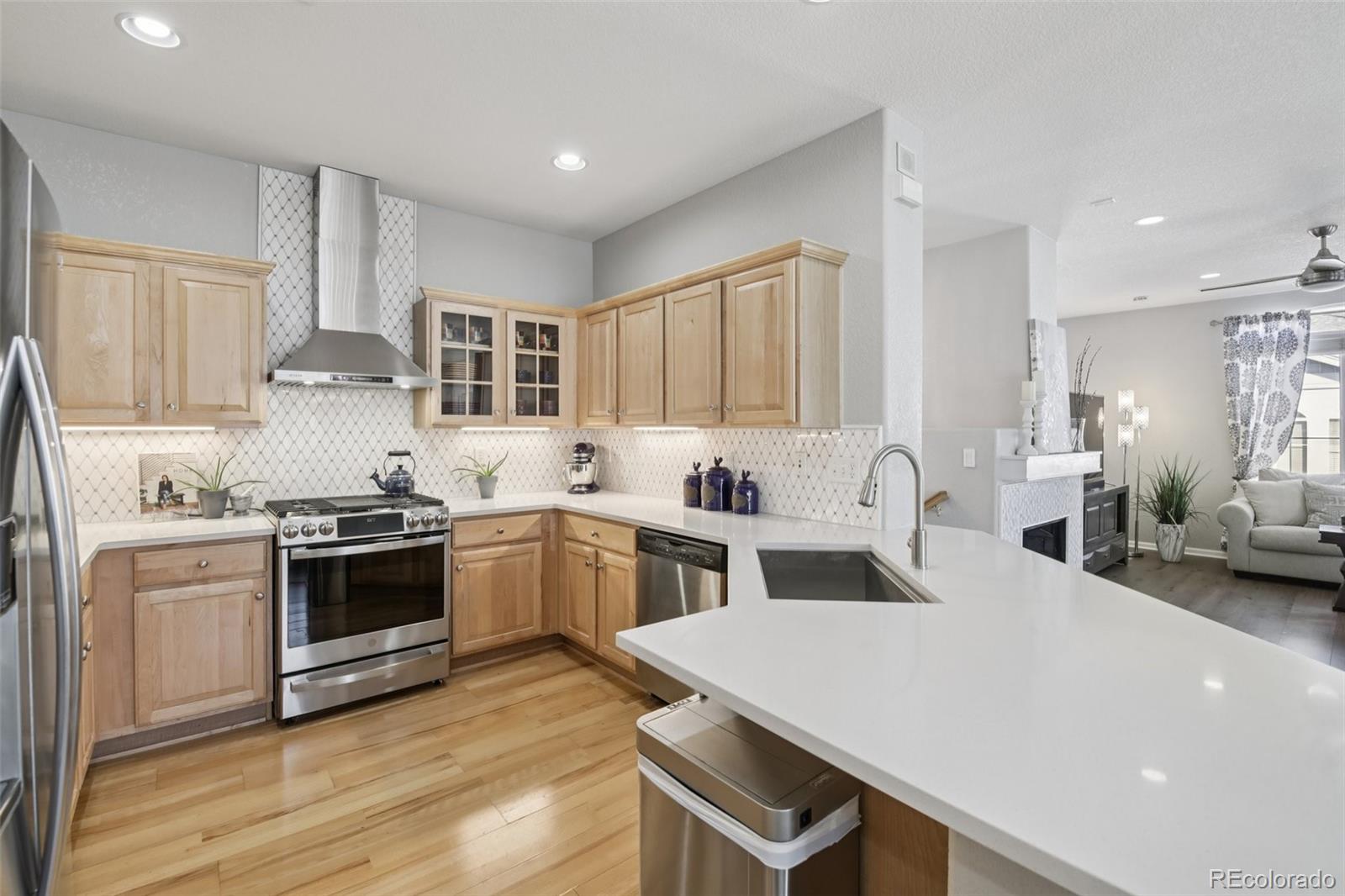 224 Whitehaven Circle Highlands Ranch, CO 80129 - Photo 4 of 34 a kitchen with a stove and white cabinets