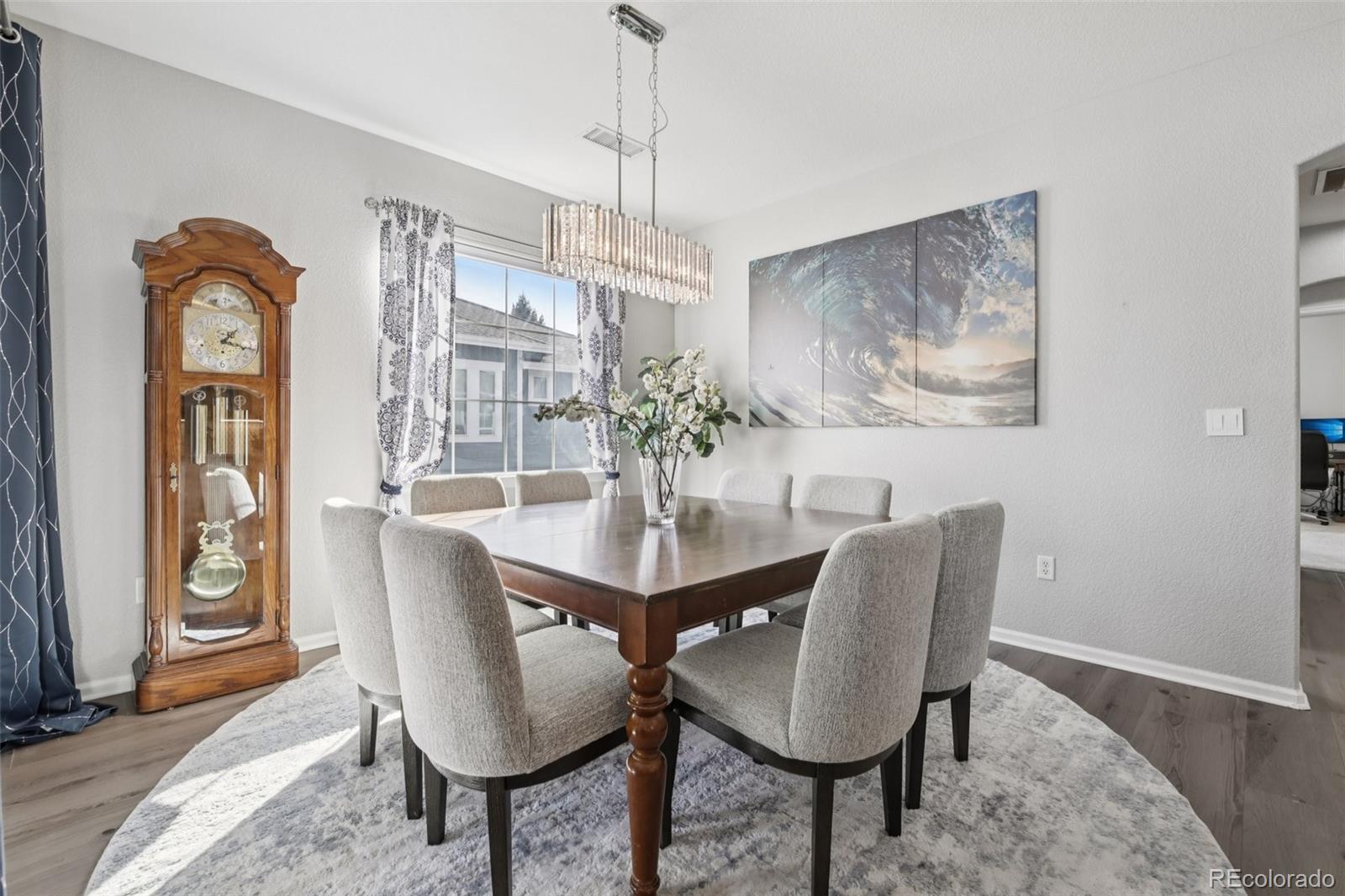 224 Whitehaven Circle Highlands Ranch, CO 80129 - Photo 8 of 34 a view of a dining room with furniture and chandelier