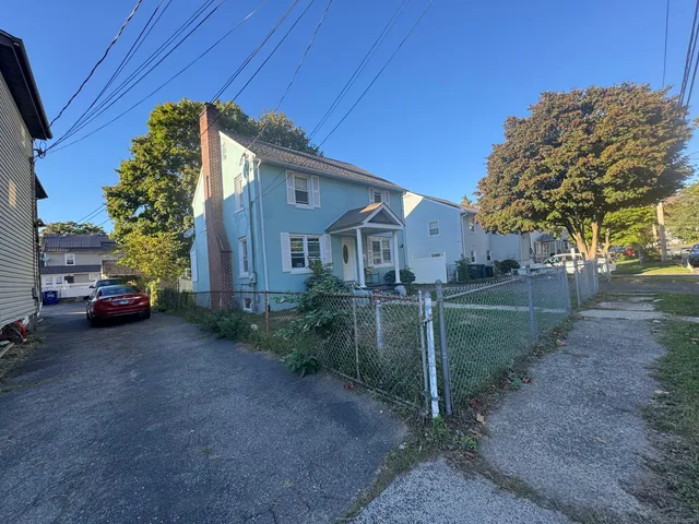 a view of a house with a backyard