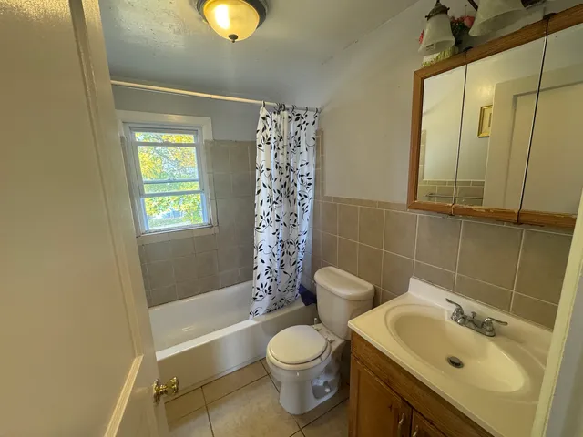 a bathroom with a sink toilet and mirror