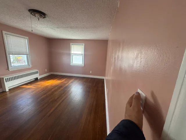 wooden floor in an empty room with a window