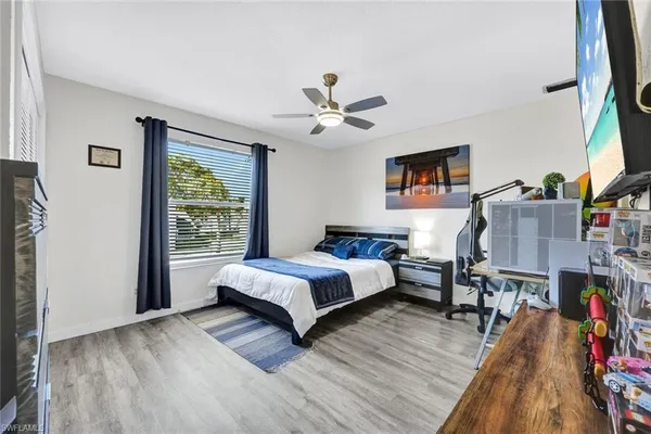 a spacious bedroom with a bed and a book shelf