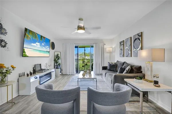 a living room with furniture and a large window