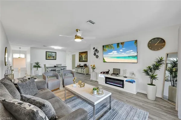 a living room with furniture and wooden floor