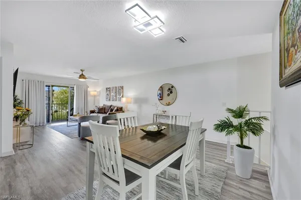 a view of a dining room with furniture window and wooden floor